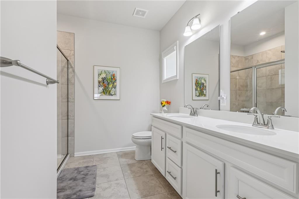 332 Red Bud Lane Washington, PA 15301 - Photo 16 of 47 a spacious bathroom with a double vanity sink mirror and toilet