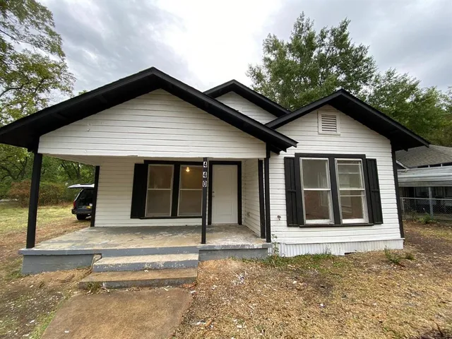 a house with trees in the background