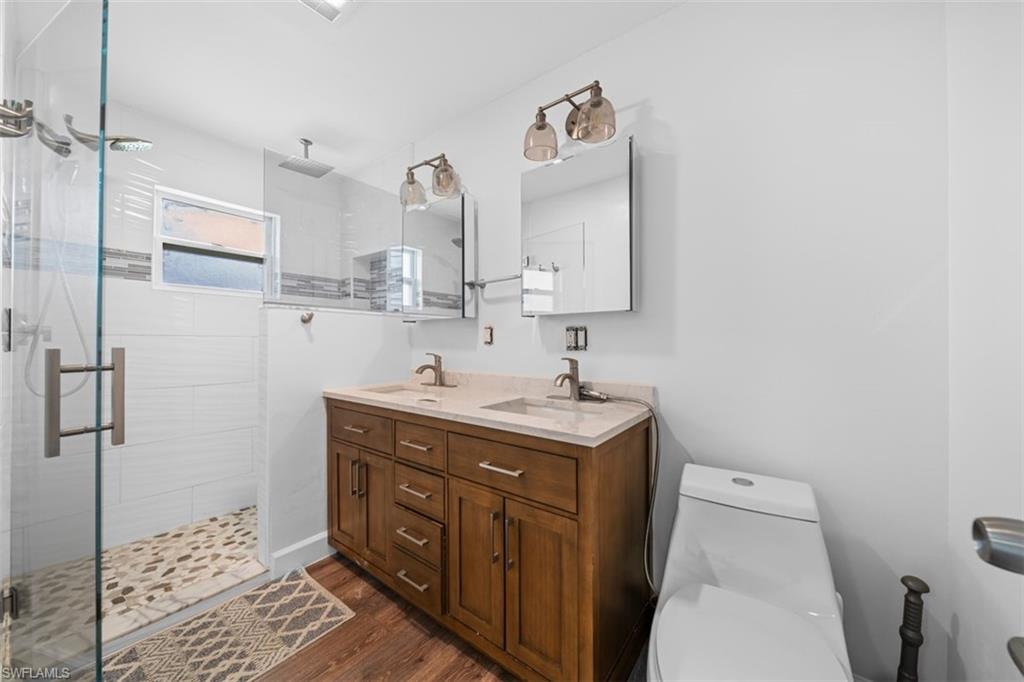 5460 Bayshore Road North Fort Myers, FL 33917 - Photo 13 of 14 a bathroom with a sink a toilet and shower