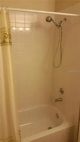 a bathroom with a shower and a shower