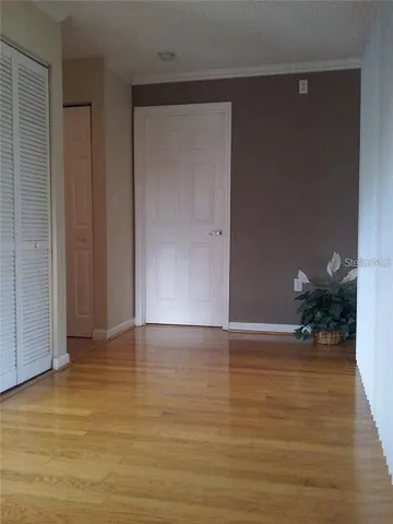 a view of an empty room and wooden floor