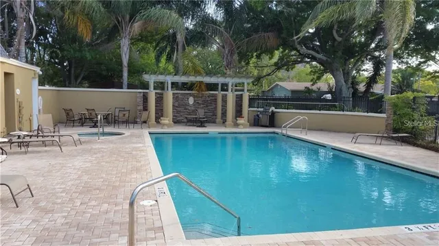 a view of a swimming pool with a patio