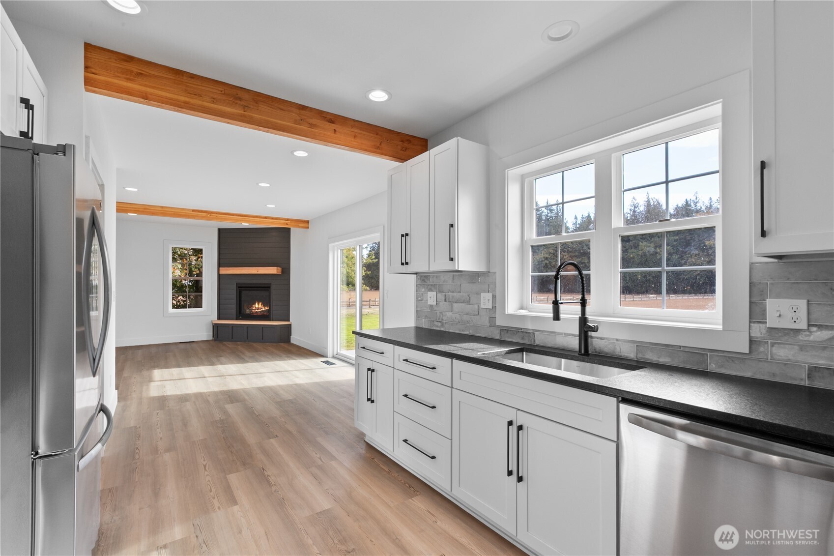 893 Loomis Trail Road Lynden, WA 98264 - Photo 12 of 39 a open kitchen with granite countertop a sink and dishwasher refrigerator a oven with wooden floors