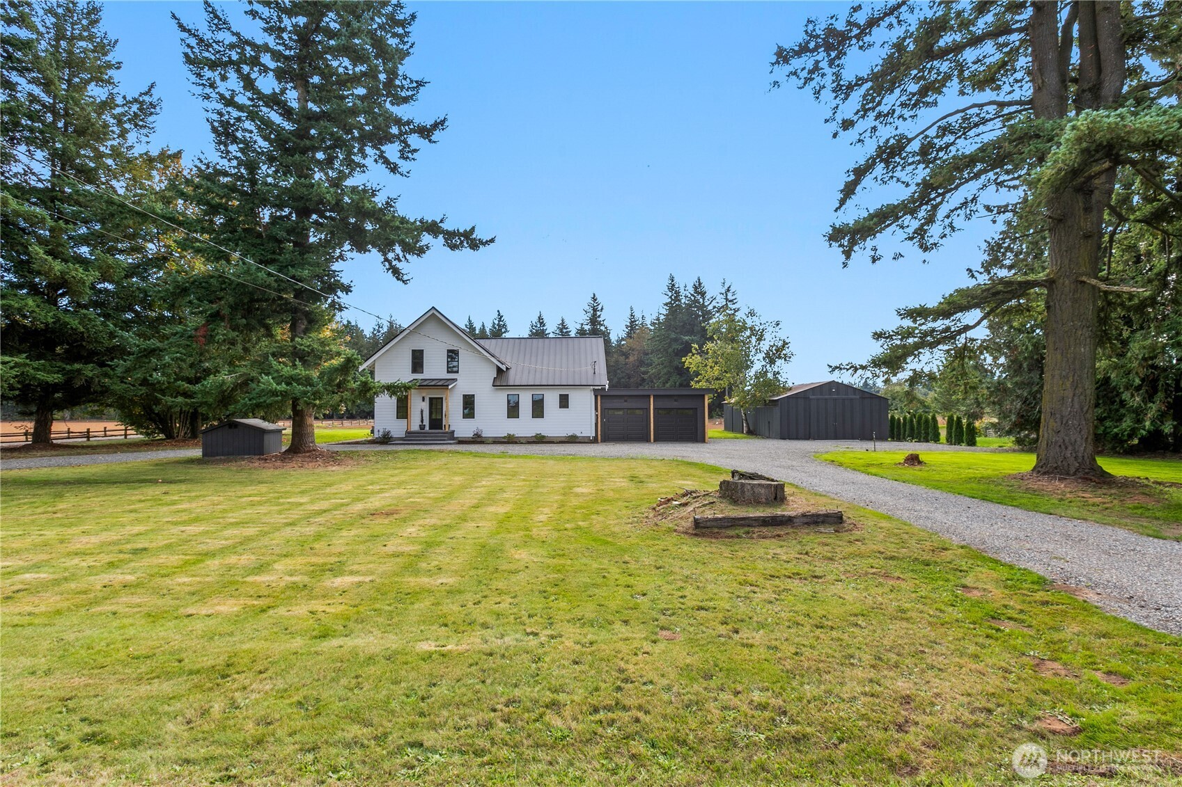 893 Loomis Trail Road Lynden, WA 98264 - Photo 2 of 39 a view of a swimming pool with lawn chairs and large trees