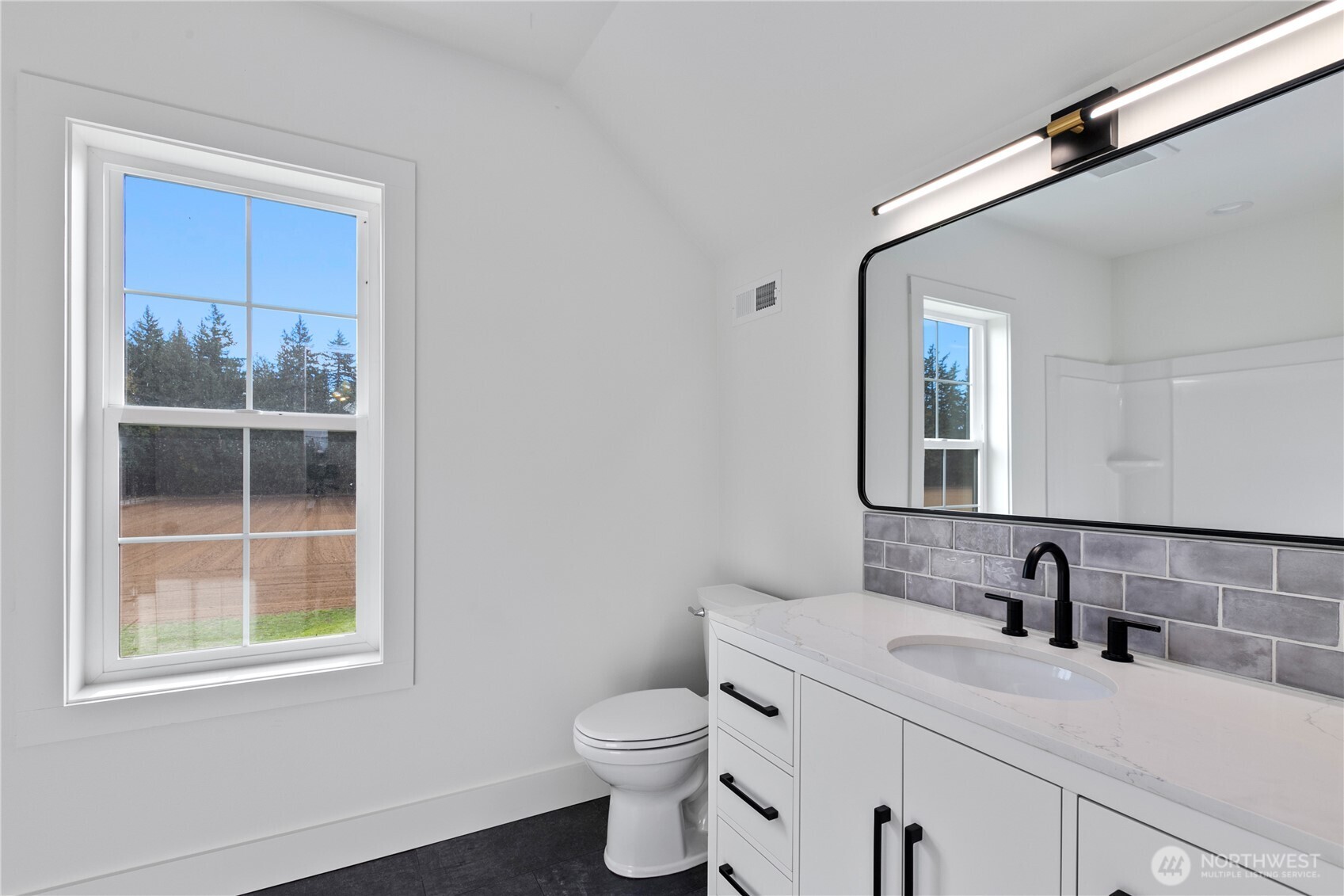 893 Loomis Trail Road Lynden, WA 98264 - Photo 23 of 39 a bathroom with a granite countertop sink mirror vanity and toilet