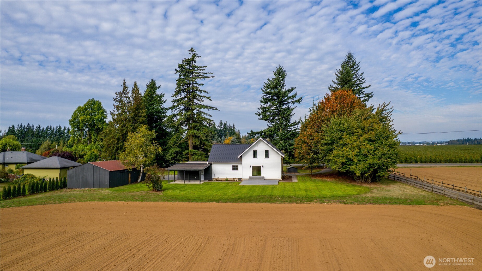 893 Loomis Trail Road Lynden, WA 98264 - Photo 34 of 39 a white house with a yard and a large parking space