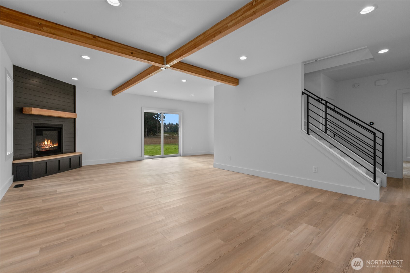 893 Loomis Trail Road Lynden, WA 98264 - Photo 6 of 39 a view of an empty room with wooden floor fireplace and a window