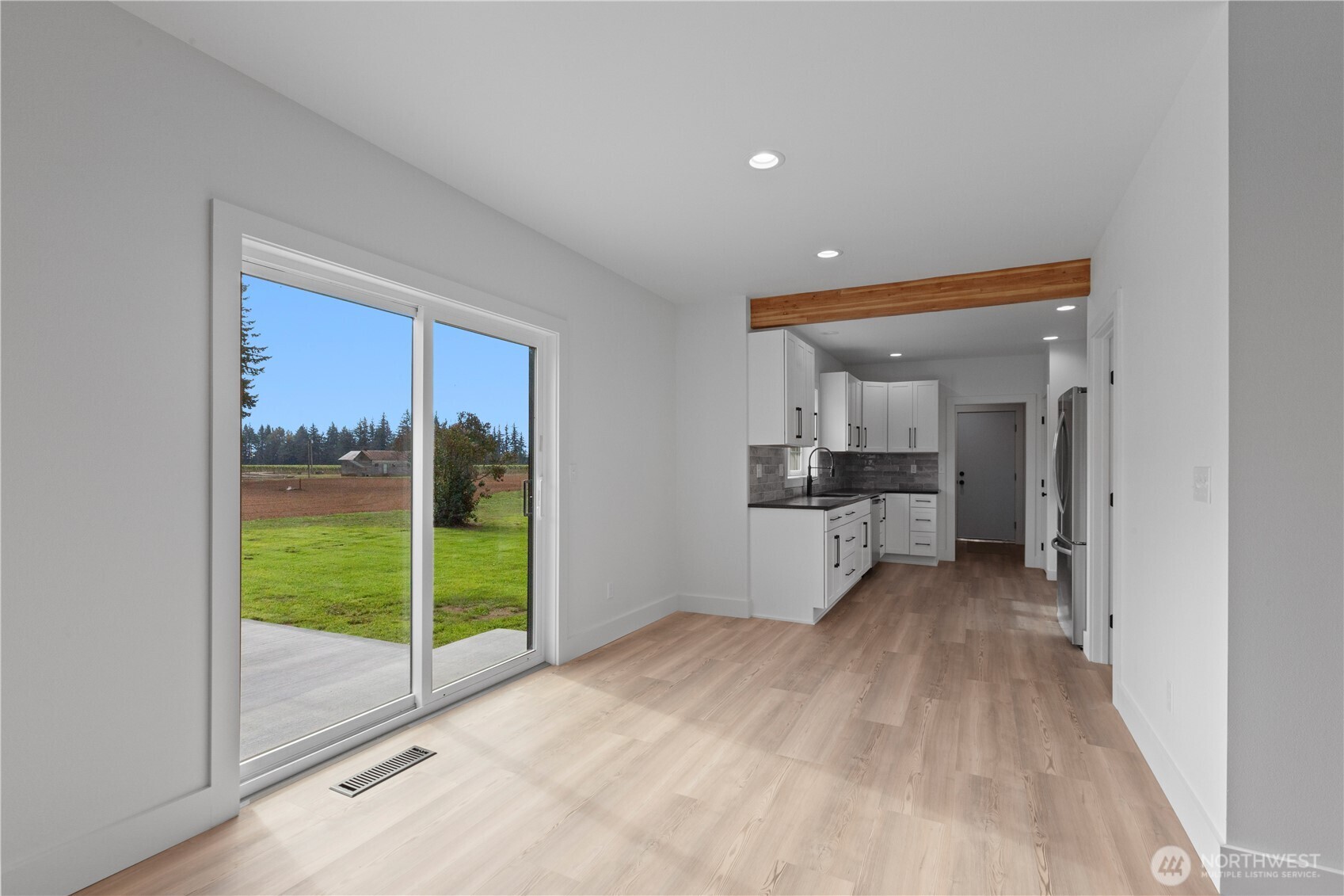 893 Loomis Trail Road Lynden, WA 98264 - Photo 9 of 39 a view of empty room with wooden floor and fireplace
