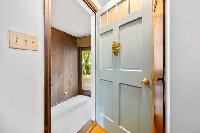 a view of hallway with paintings on the wall