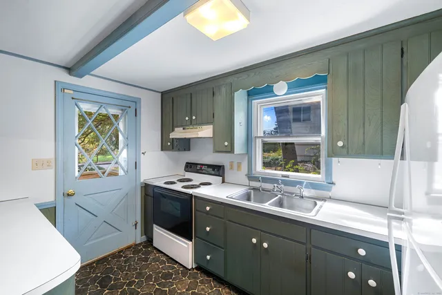 a kitchen with stainless steel appliances granite countertop a sink stove and cabinets