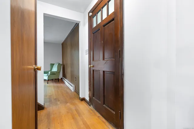 a view of a hallway with living room and utility room