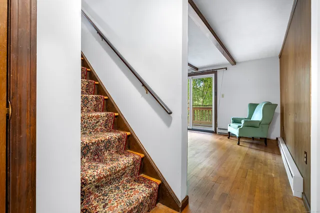 a bed sitting in a bedroom next to a window