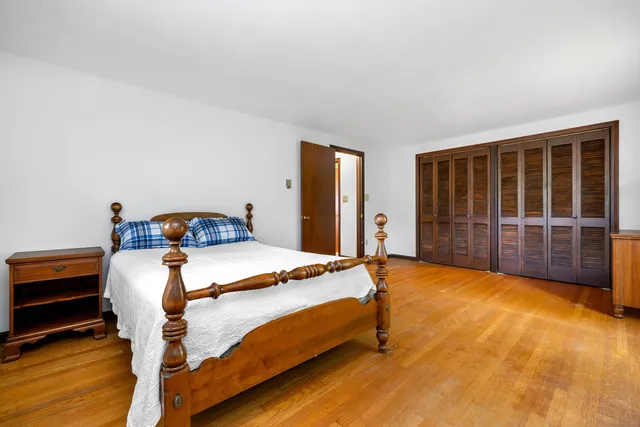 a bed room with a bed and paintings on the wall