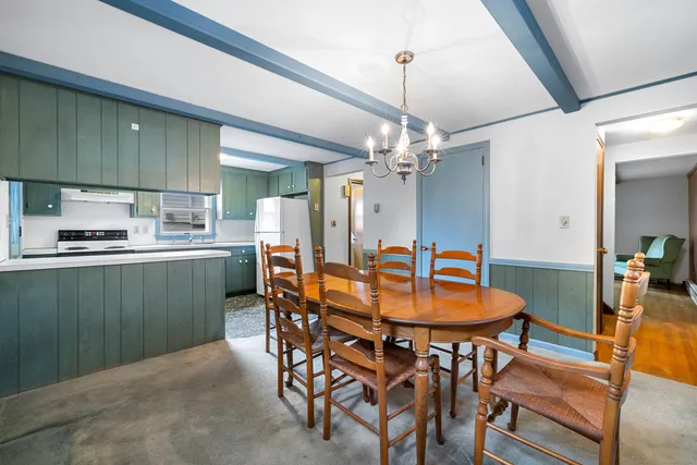 a dining room with furniture and window