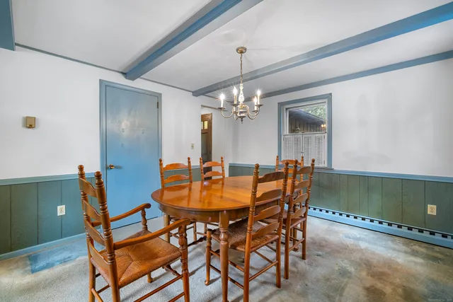 a view of a dining room with furniture and chandelier
