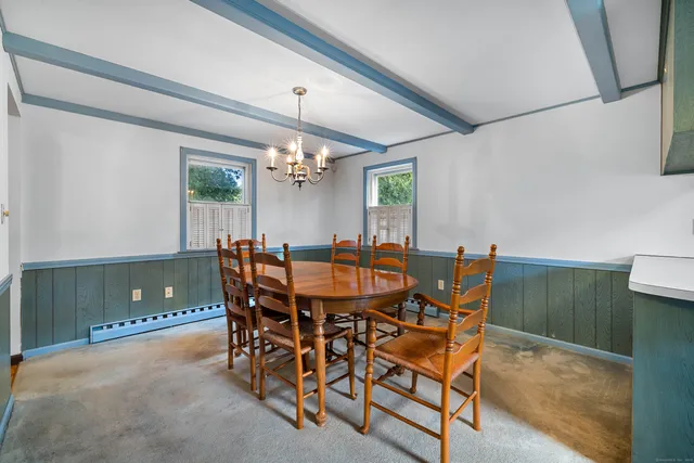 a view of a dining room with furniture and chandelier