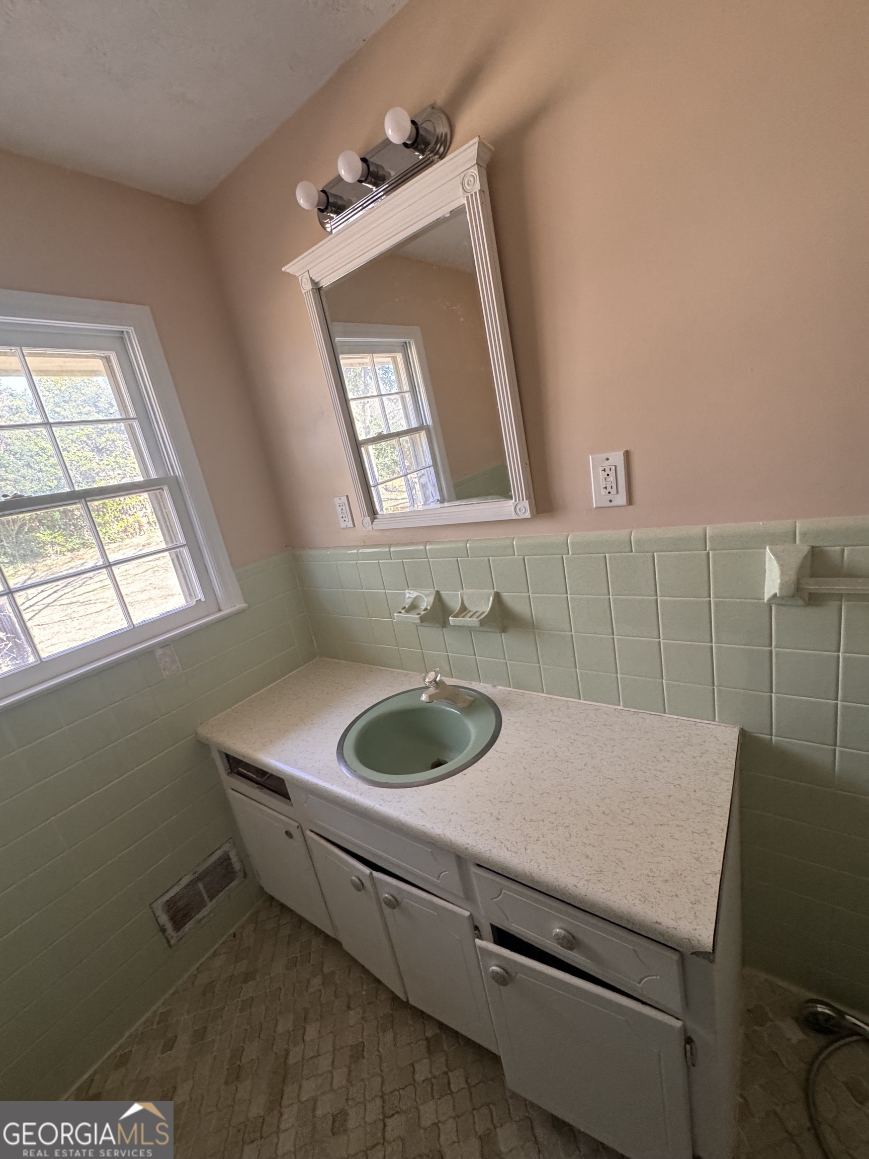 5175 Forest Drive Southeast Covington, GA 30014 - Photo 13 of 30 a bathroom with a sink and a mirror