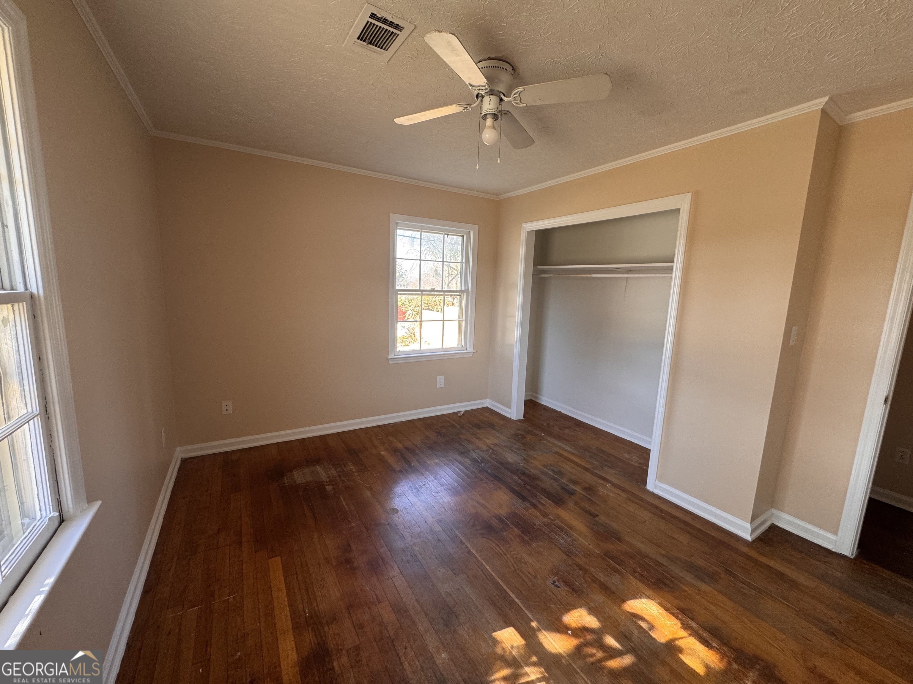 5175 Forest Drive Southeast Covington, GA 30014 - Photo 19 of 30 a view of an empty room with wooden floor and a window