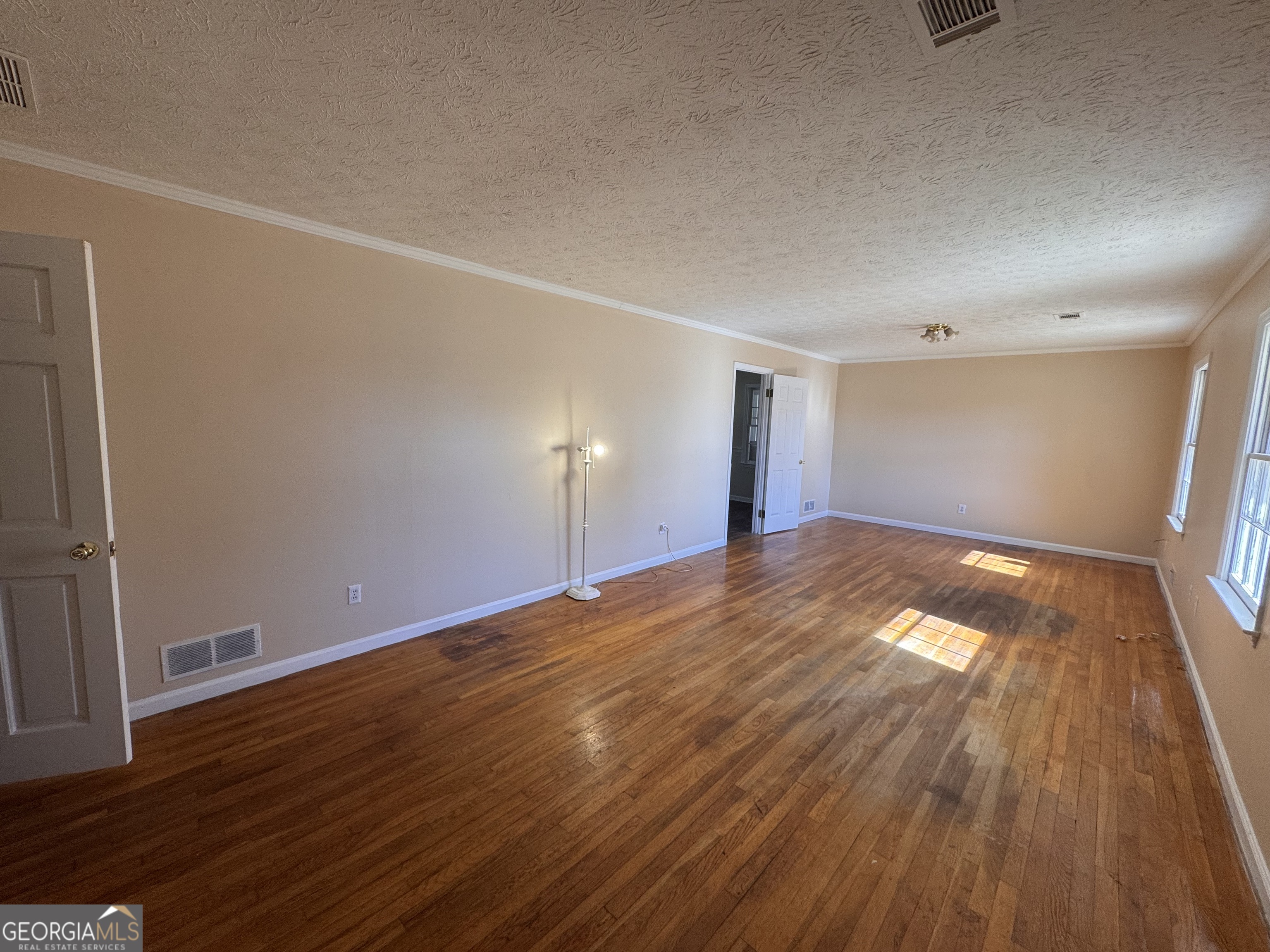 5175 Forest Drive Southeast Covington, GA 30014 - Photo 3 of 30 wooden floor in an empty room with a window