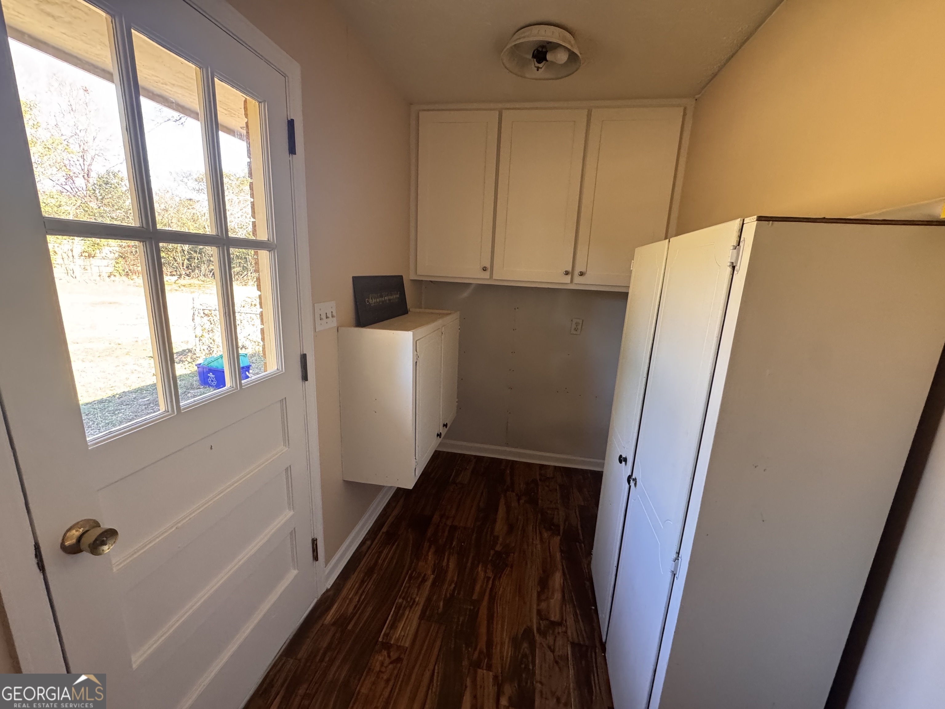 5175 Forest Drive Southeast Covington, GA 30014 - Photo 8 of 30 a view of an empty room with wooden floor and a window
