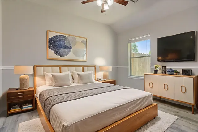 a bedroom with a bed and a large window