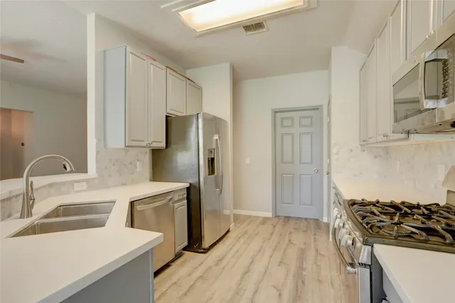 a view of a livingroom with furniture a fireplace window and wooden floor