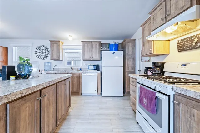 a kitchen with a sink stove and refrigerator