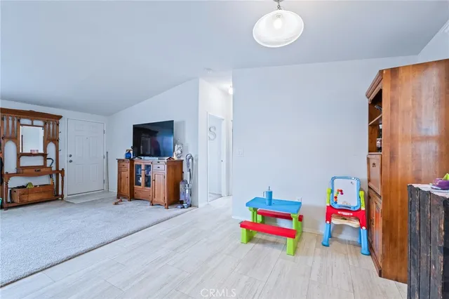 a bedroom with a bed and a refrigerator