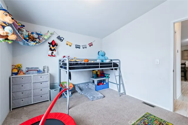 a living room with furniture cabinets and a flat screen tv