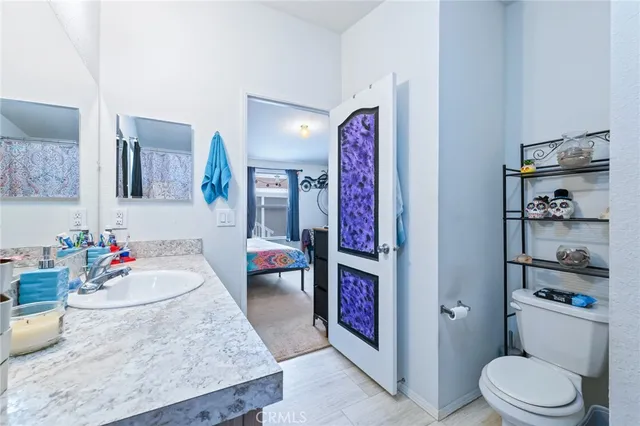 a en suite bathroom with a sink double vanity and a mirror