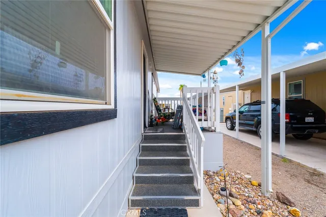 a view of staircase with lots of frames on wall and a potted plant
