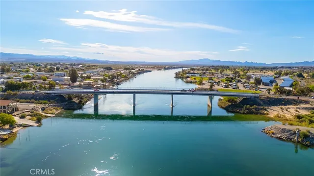 an aerial view of residential houses with outdoor space and ocean view