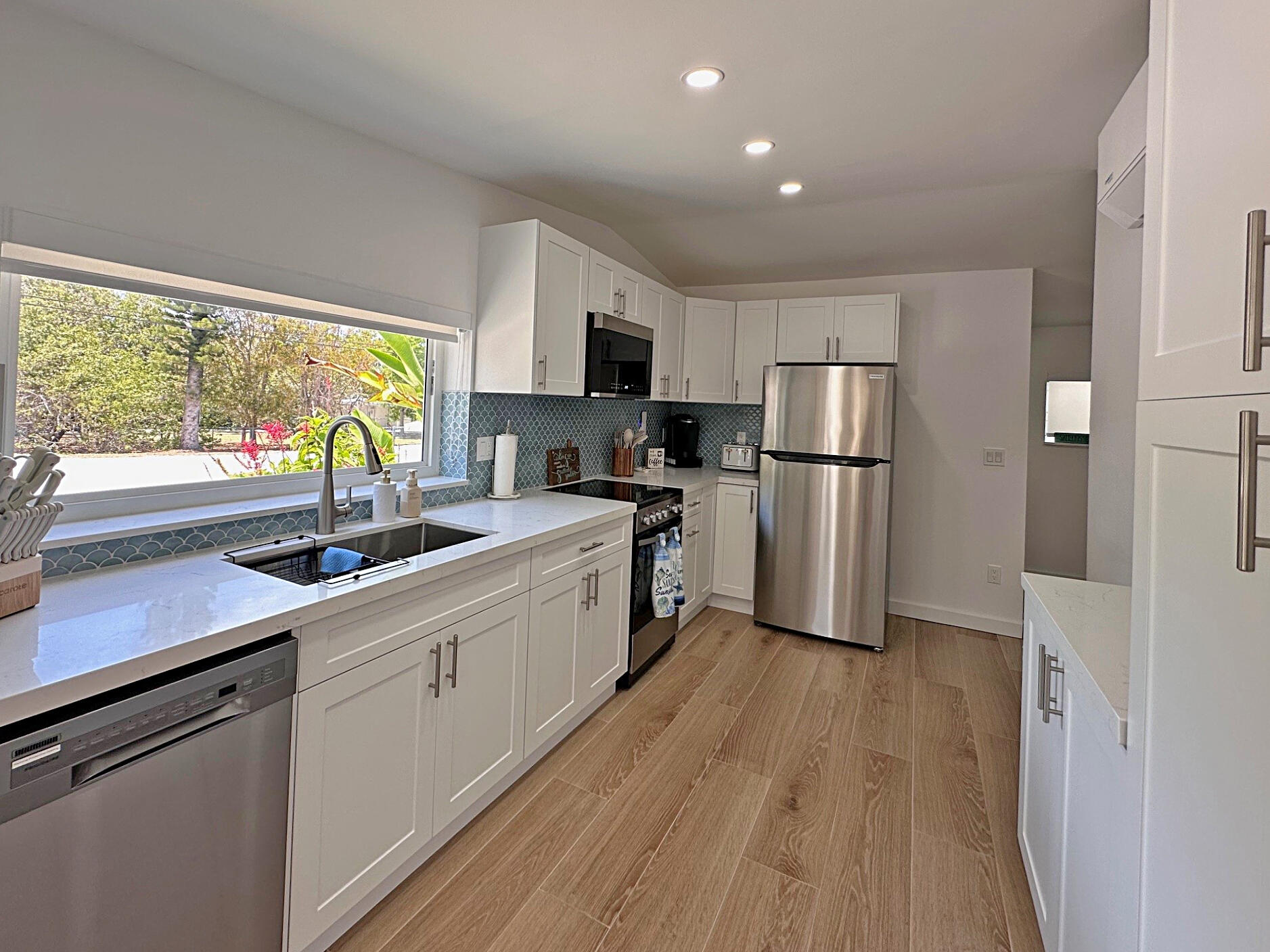 32 Pirates Drive Key Largo, FL 33037 - Photo 7 of 25 a kitchen with white cabinets and white appliances