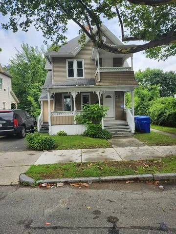 a front view of a house with a yard and a garage