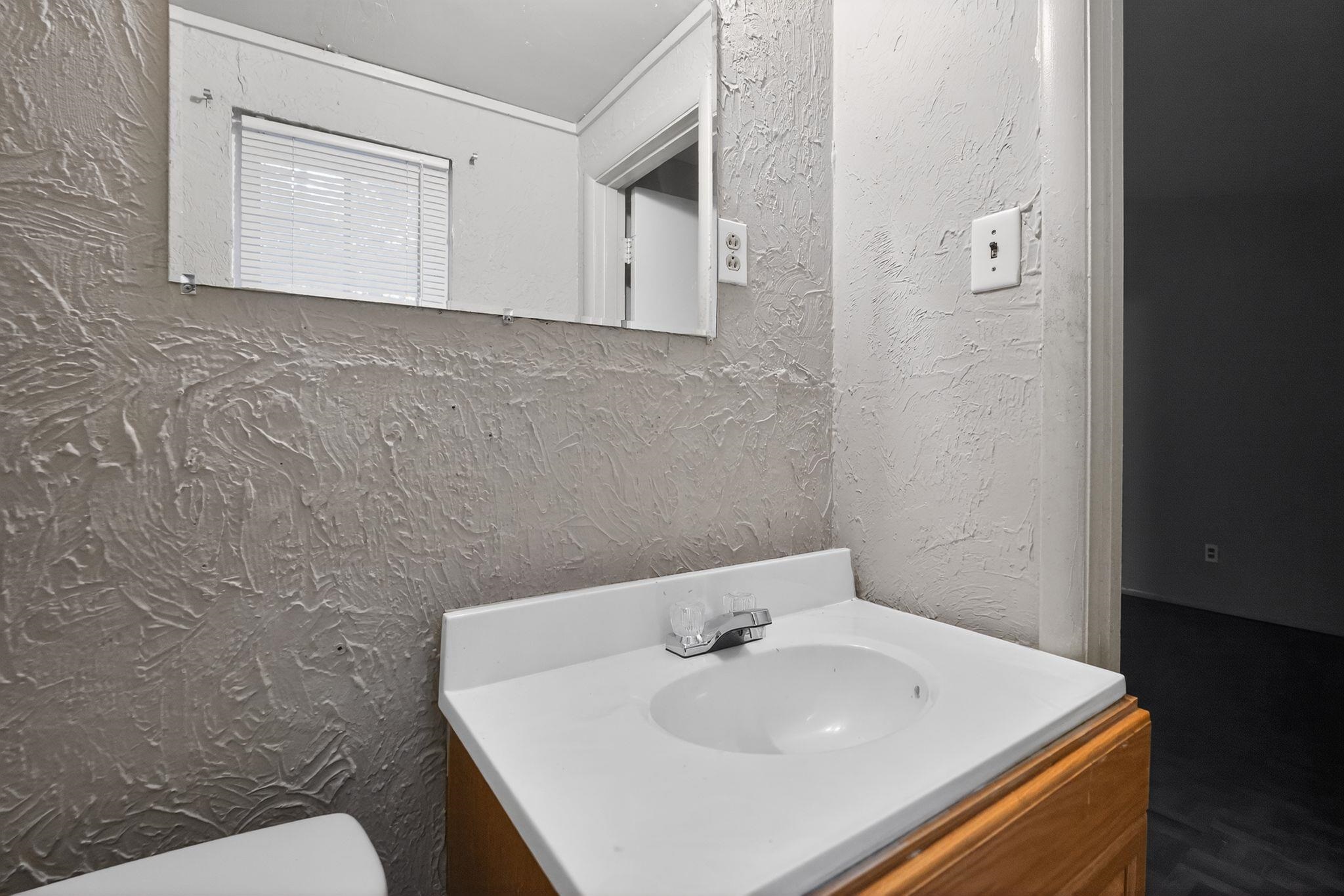 4504 Neely Road Memphis, TN 38109 - Photo 22 of 32 a bathroom with a sink and a toilet