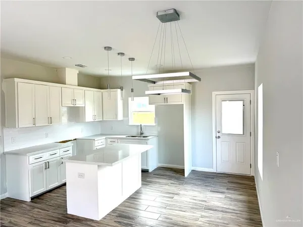 a kitchen with a stove a sink and a refrigerator
