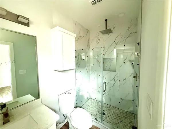 a bathroom with a sink toilet and shower