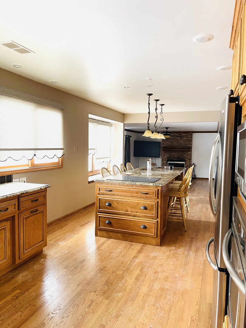 562 Boardman Circle Bolingbrook, IL 60440 - Photo 4 of 14 a room with furniture and flat screen tv