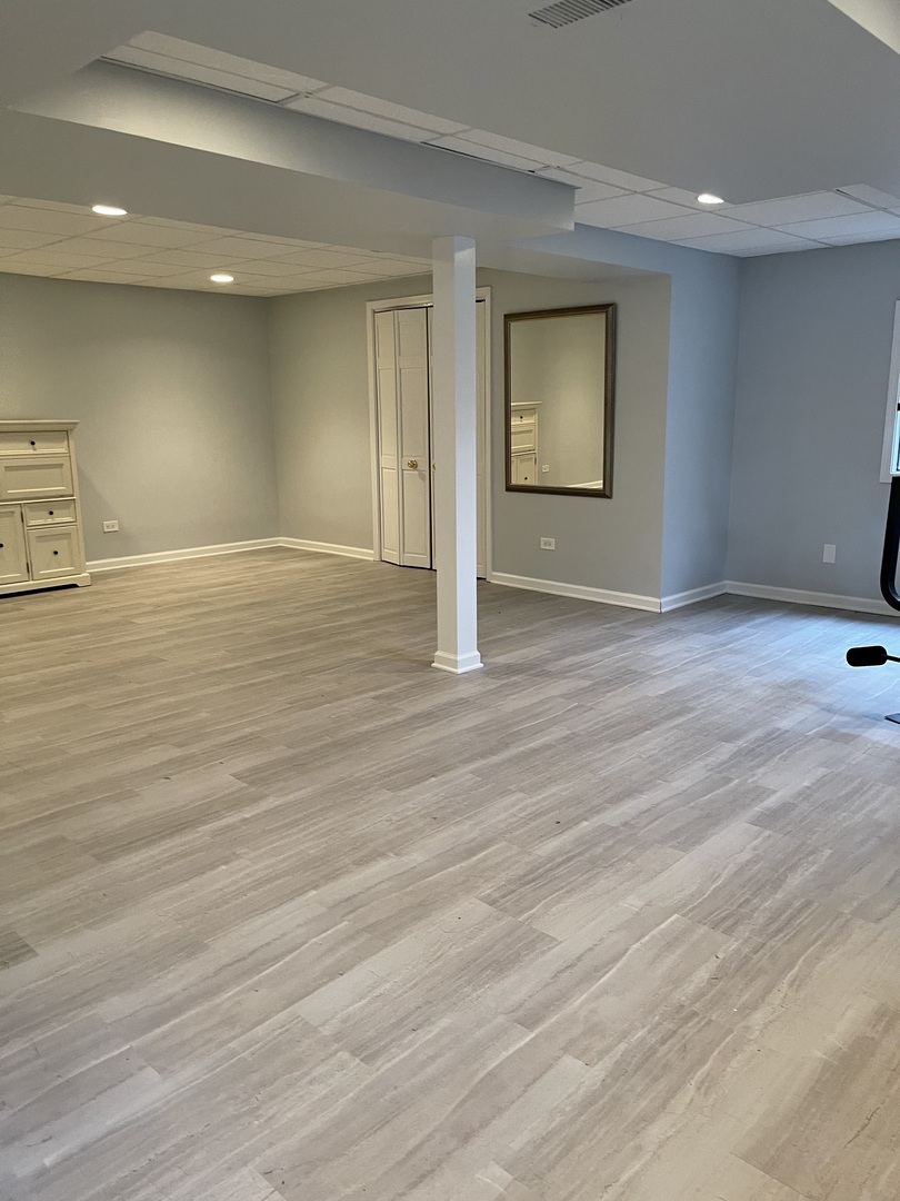 562 Boardman Circle Bolingbrook, IL 60440 - Photo 8 of 14 an empty room with wooden floor and windows