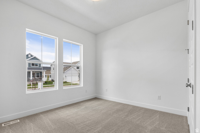 43 South Crimson Way, Unit 311 Mapleton, UT 84664 - Photo 11 of 28 Bright room featuring two large windows, neutral carpeting, white baseboards, and a contemporary flush-mount ceiling light
