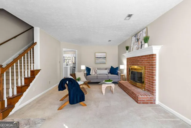 a living room with furniture and a fireplace