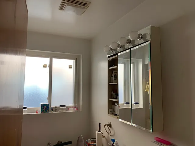 a bathroom with a mirror and a shower