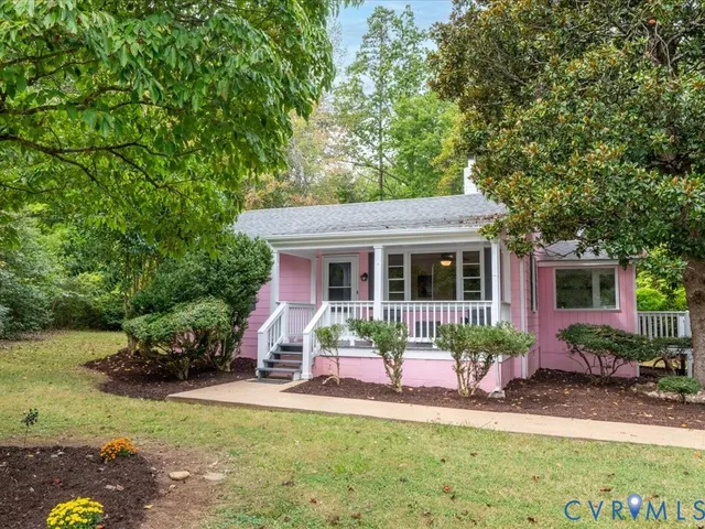 a front view of a house with a yard table and chairs