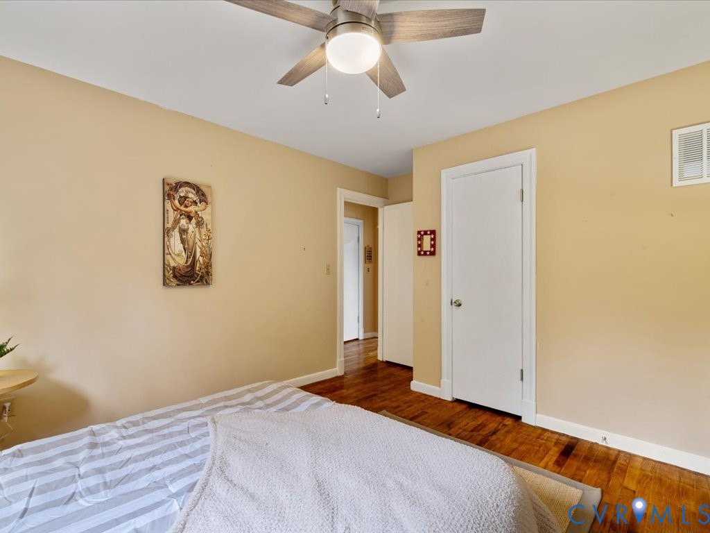7068 Porters Road Esmont, VA 22937 - Photo 22 of 37 a bedroom with a bed and a chandelier