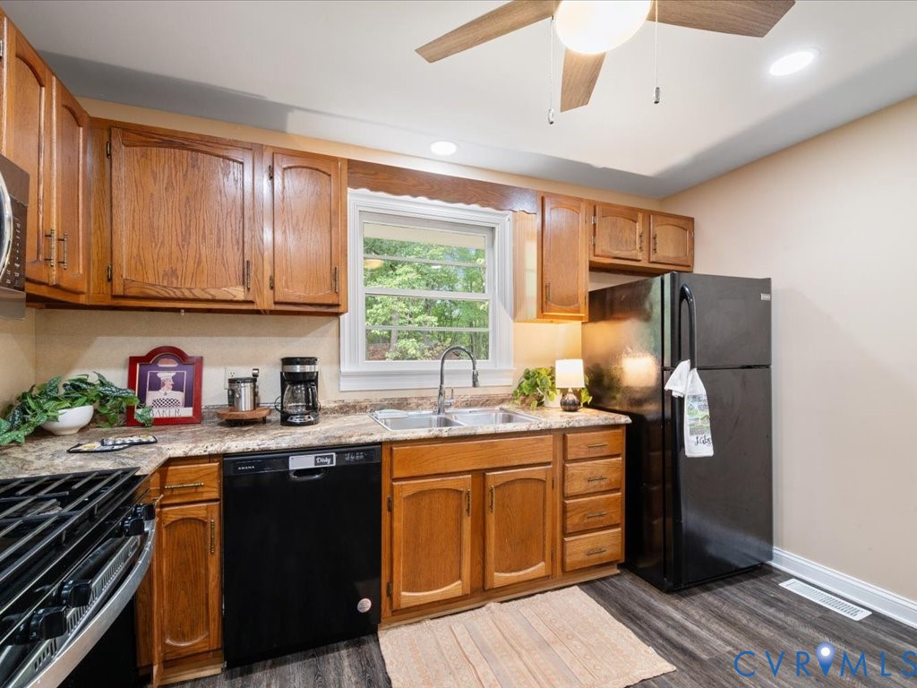 7068 Porters Road Esmont, VA 22937 - Photo 25 of 37 a kitchen with stainless steel appliances granite countertop a sink stove and refrigerator