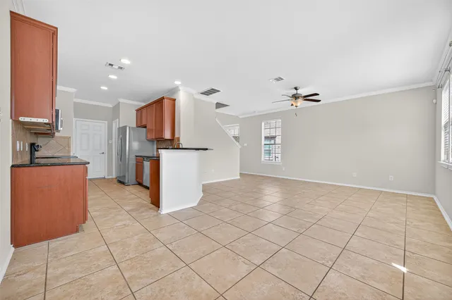 a view of kitchen with refrigerator cabinets and microwave