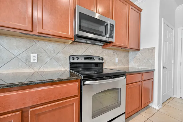 a kitchen with wooden cabinets and a stove top oven