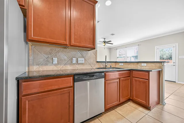 a kitchen with granite countertop cabinets and sink