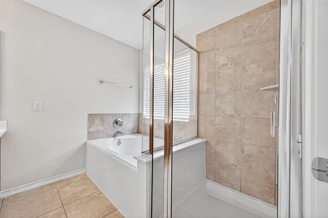 a bathroom with a bathtub and shower