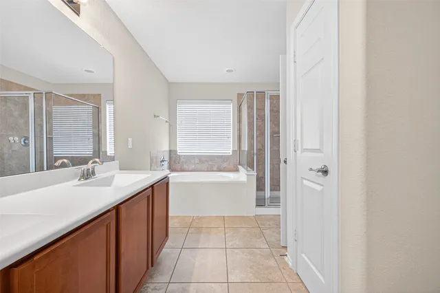 a bathroom with a bathtub sink and mirror